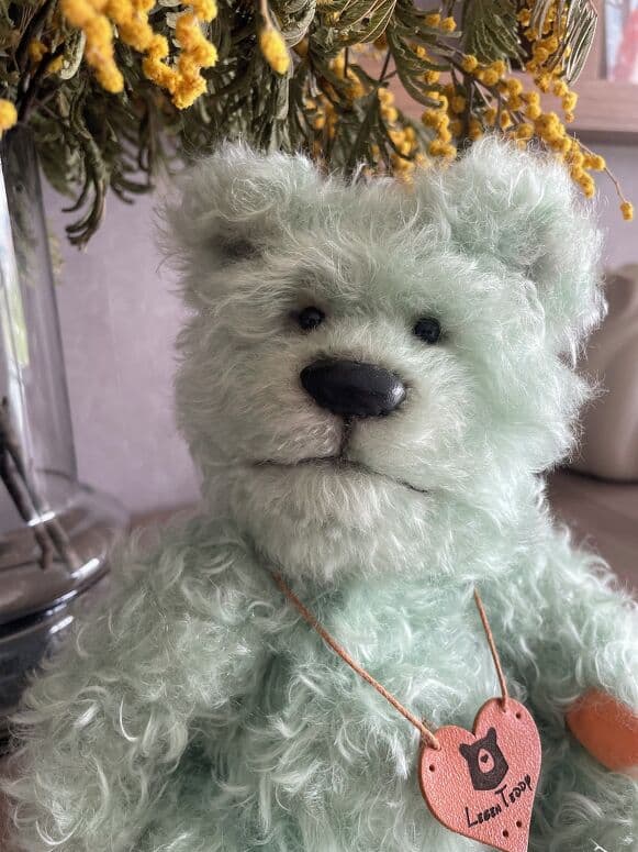 Portrait of Moss, a mist-green hand-dyed mohair artist bear