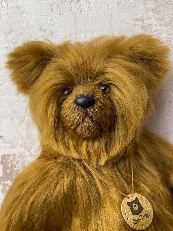 Portrait of Tobias, an olive-gold mohair artist bear