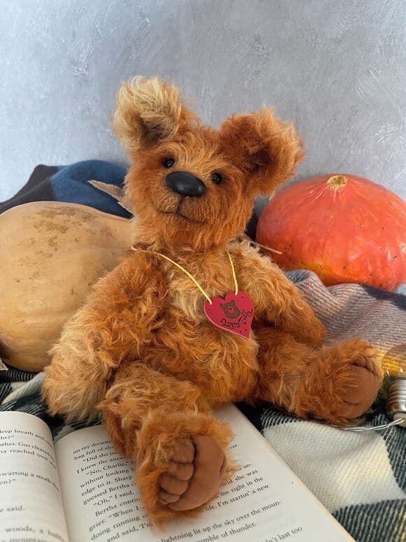 Ambear, a handmade artist bear, photographed in an autumn setting