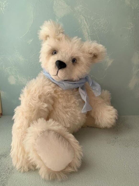 Yuki, a snow-white mohair artist bear, seated full length