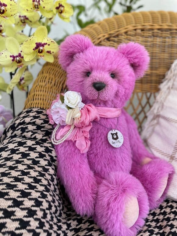 Loona, a bubblegum-pink alpaca artist bear, seated full length