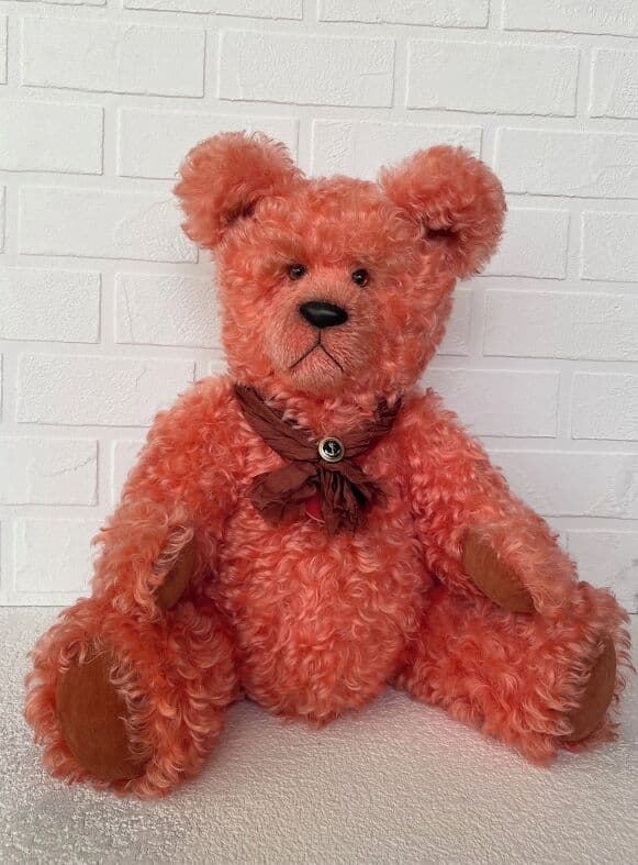 Richard, a coral kid-mohair artist bear, seated full length