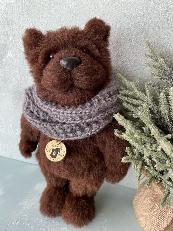 Mr. Brownie, a chocolate alpaca artist bear in a grey scarf