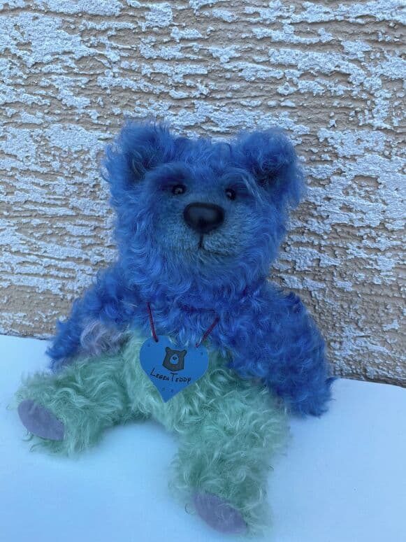 Mr. Blu Berry, a blue-and-mint mohair artist bear, seated full length